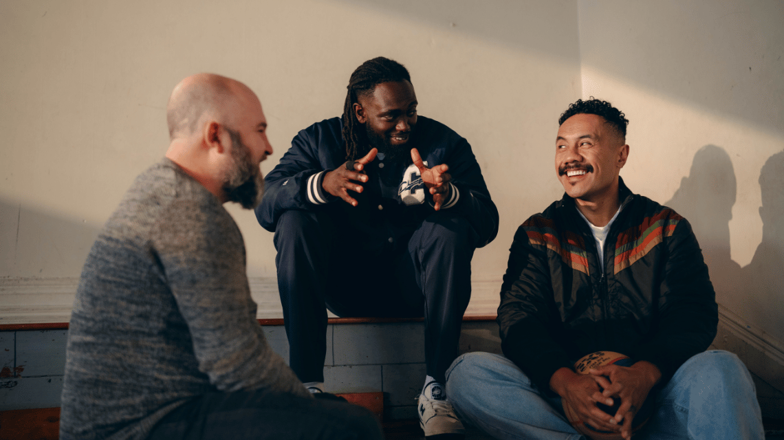 Three men sit in conversation for the What Kind of Man Do You Want to Be? campaign.